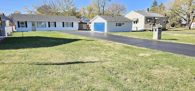 single story home featuring a garage, an outdoor structure, and a front lawn