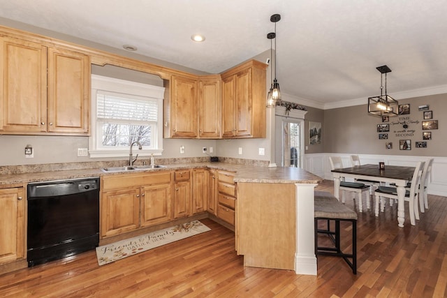 kitchen with sink, dishwasher, hanging light fixtures, a kitchen breakfast bar, and kitchen peninsula