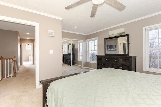 bedroom featuring light carpet, crown molding, and ceiling fan