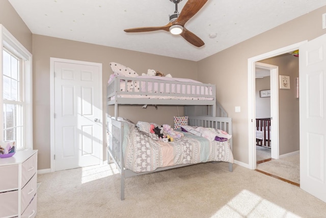 bedroom with light carpet and ceiling fan