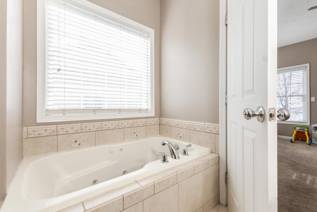 bathroom featuring a relaxing tiled tub