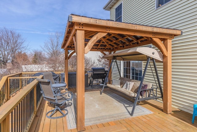 deck with area for grilling and a hot tub