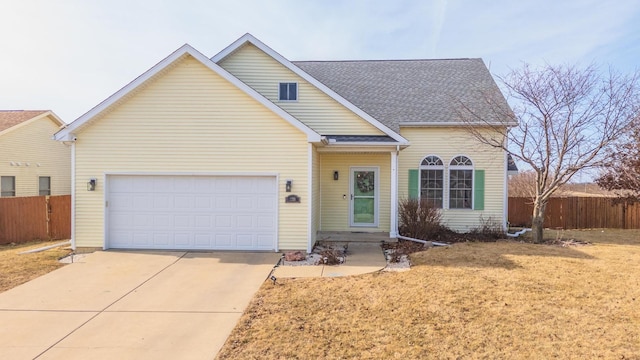 view of front of property featuring a garage and a front lawn