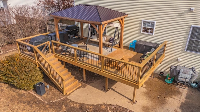 wooden terrace with a gazebo, area for grilling, and an outdoor hangout area