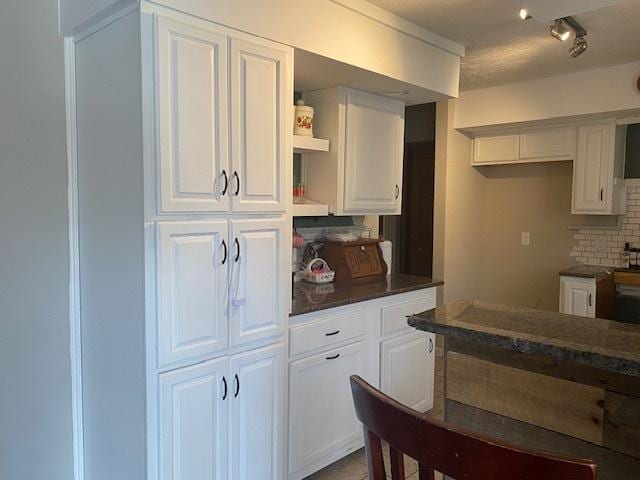 kitchen with white cabinetry and backsplash