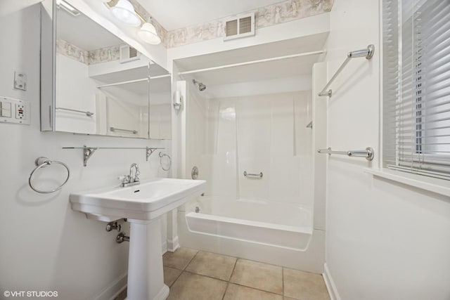 bathroom featuring tile patterned floors, visible vents, baseboards, and  shower combination