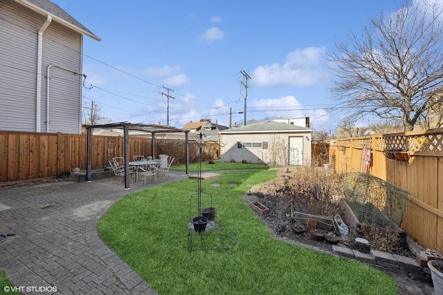 view of yard with an outdoor structure, a fenced backyard, and a patio