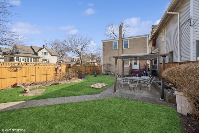 view of yard with a patio, a fenced backyard, and a residential view