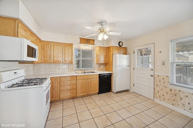 kitchen featuring ceiling fan, light countertops, light tile patterned floors, white appliances, and a sink