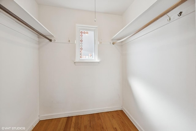 walk in closet featuring wood finished floors