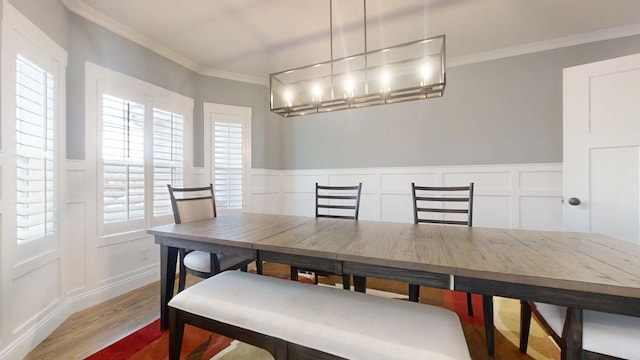 dining room featuring hardwood / wood-style flooring and crown molding