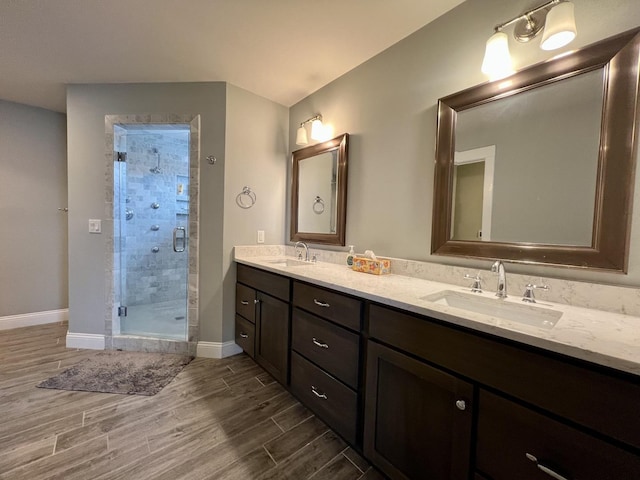 bathroom featuring vanity and an enclosed shower