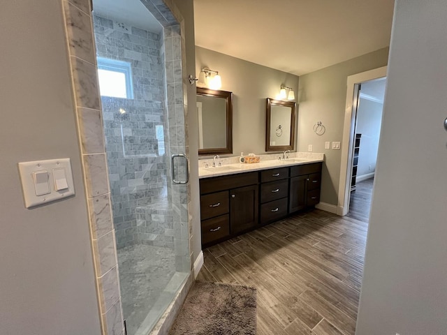 bathroom with vanity, an enclosed shower, and wood-type flooring