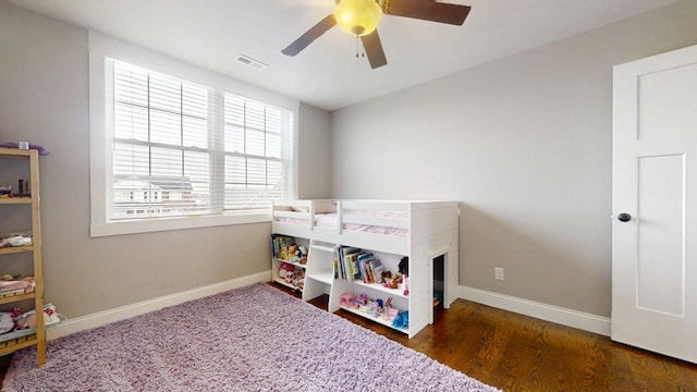 bedroom featuring dark hardwood / wood-style floors and ceiling fan