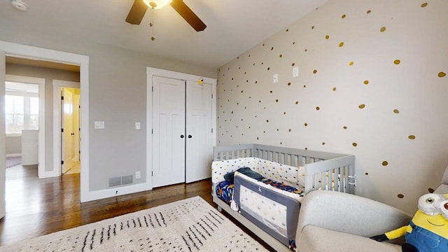 bedroom with ceiling fan, a closet, and dark hardwood / wood-style flooring