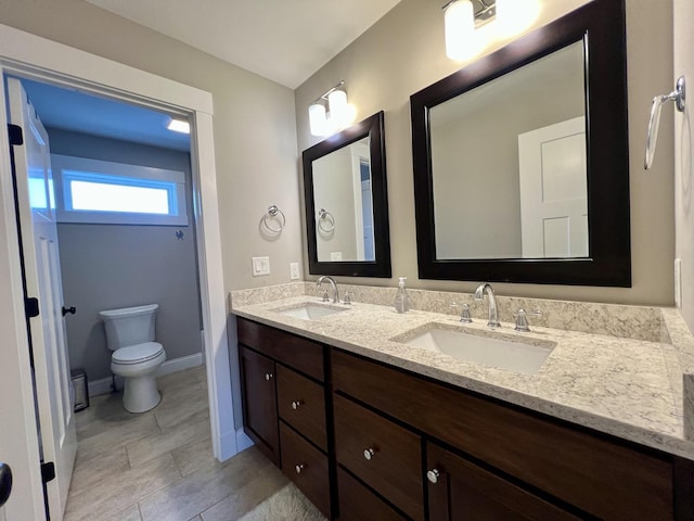 bathroom with toilet and vanity