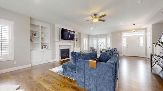 living room with ceiling fan and hardwood / wood-style floors