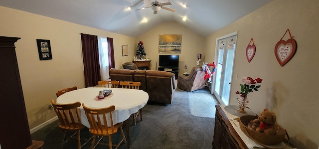 carpeted dining area with vaulted ceiling and ceiling fan