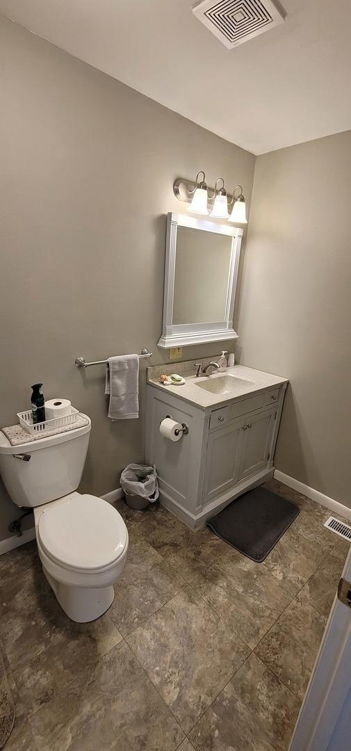 bathroom featuring vanity and toilet