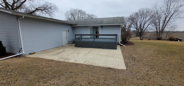 rear view of property with a patio, a deck, and a lawn