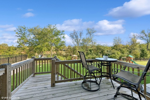 wooden deck featuring a playground