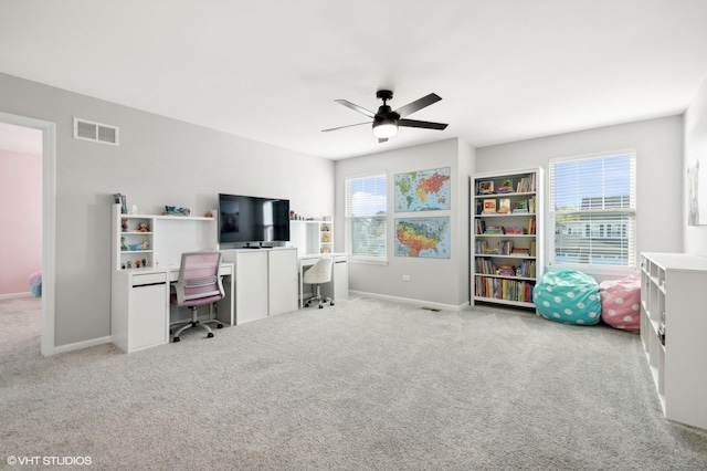 office space featuring light colored carpet and ceiling fan