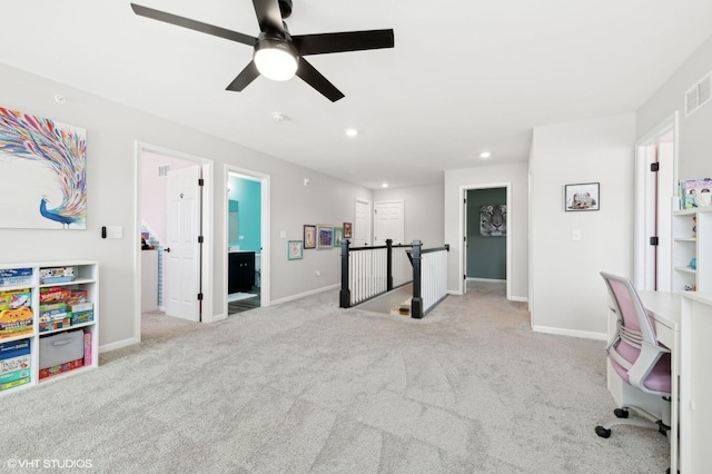 carpeted home office with ceiling fan