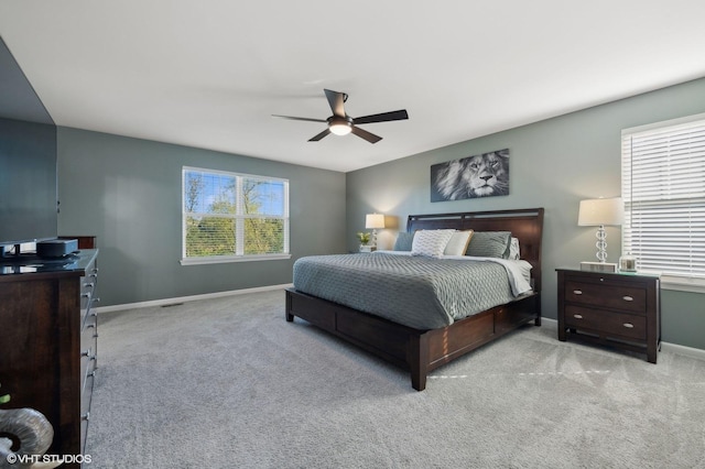 bedroom with ceiling fan and light carpet