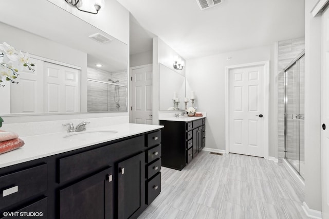 bathroom featuring walk in shower and vanity