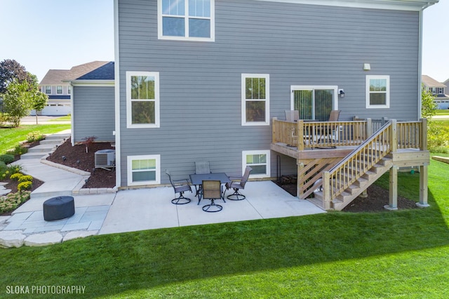 back of house with a wooden deck, central air condition unit, a patio, and a lawn