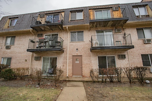 view of building exterior featuring a wall mounted air conditioner