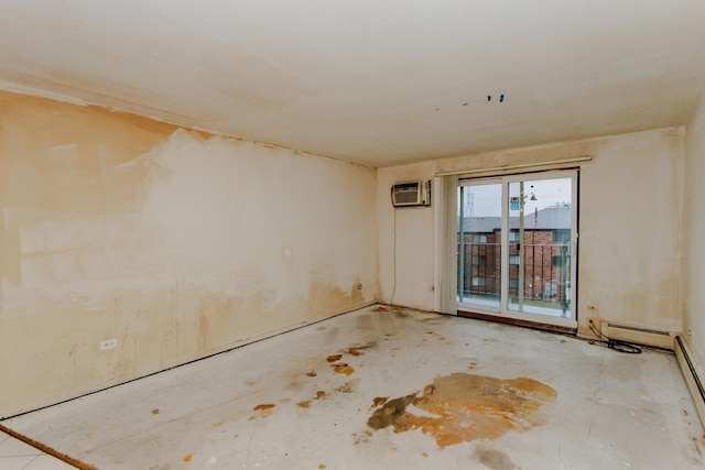 unfurnished room with a wall mounted AC and a baseboard heating unit