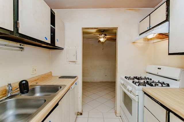 kitchen featuring sink, white appliances, ceiling fan, white cabinets, and light tile patterned flooring