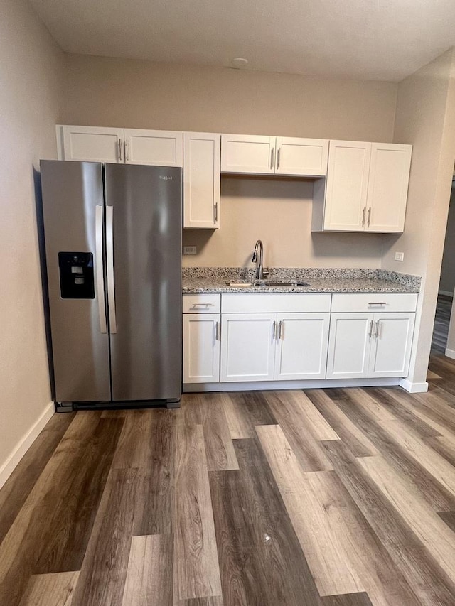 kitchen featuring white cabinetry, sink, dark hardwood / wood-style floors, and stainless steel refrigerator with ice dispenser