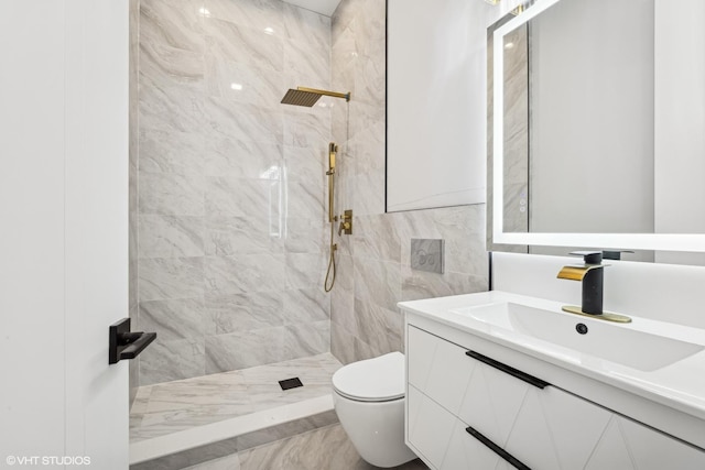 bathroom featuring vanity, toilet, and a tile shower