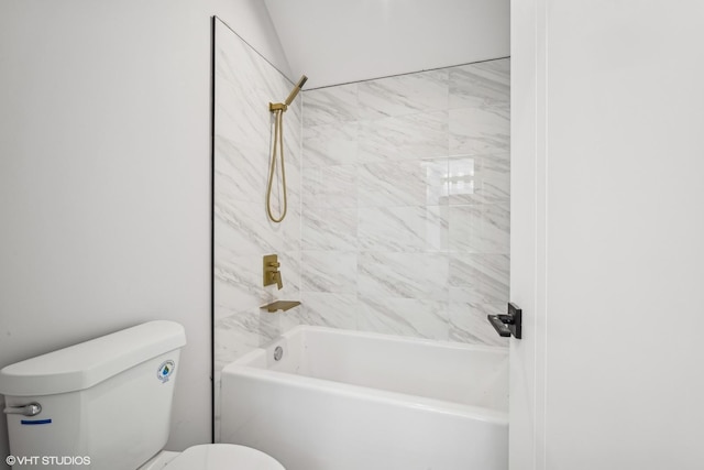 bathroom featuring tiled shower / bath and toilet