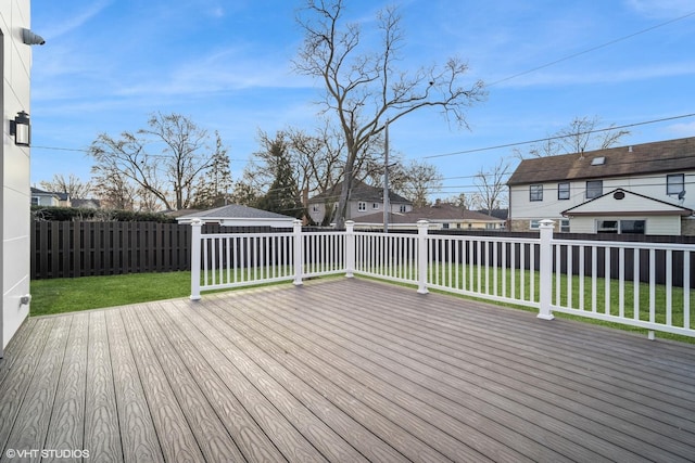 wooden terrace with a lawn