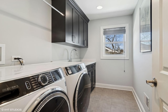 clothes washing area with cabinet space, visible vents, baseboards, washer and dryer, and a sink