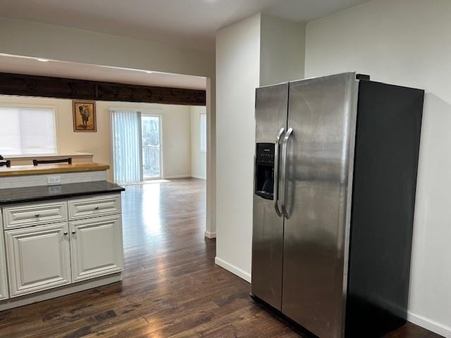 kitchen with white cabinetry, dark hardwood / wood-style flooring, and stainless steel fridge with ice dispenser