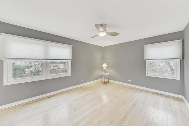 unfurnished room featuring ceiling fan, a healthy amount of sunlight, and light hardwood / wood-style floors