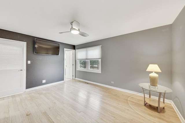 spare room featuring ceiling fan and light wood-type flooring