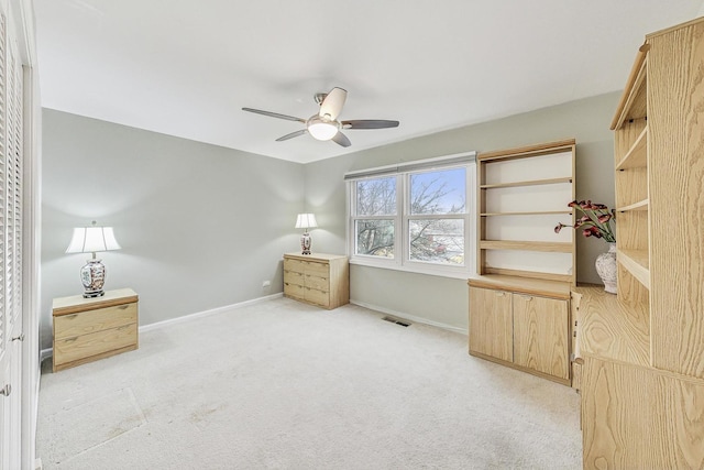 unfurnished bedroom with light colored carpet and ceiling fan