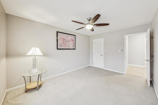 carpeted spare room featuring ceiling fan