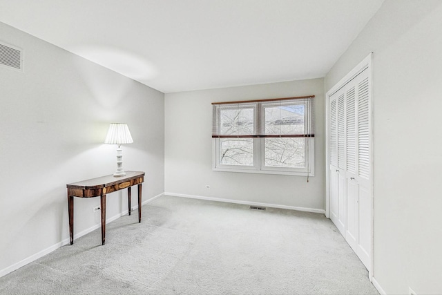 bedroom with light carpet and a closet