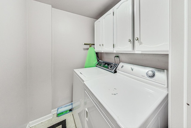 laundry room featuring cabinets and separate washer and dryer