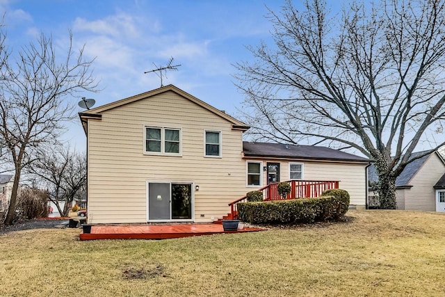 back of property featuring a yard and a deck