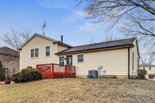 rear view of house featuring a yard, central AC, and a deck