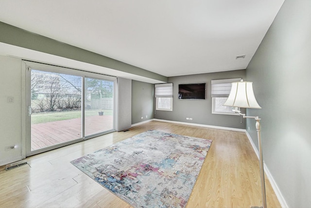 living room with wood-type flooring and a healthy amount of sunlight