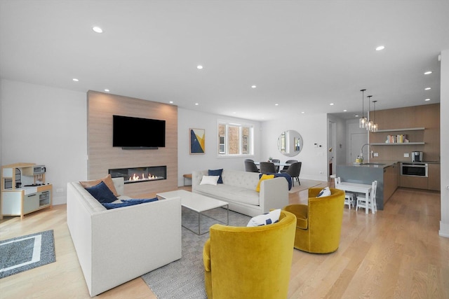 1834 N Rockwell St Unit 1R, Chicago, IL 60647 - living room featuring a large fireplace, recessed lighting, light wood finished floors, and a chandelier