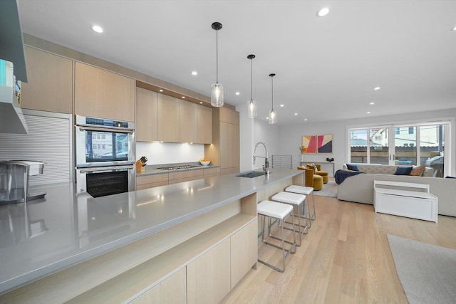 1834 N Rockwell St Unit 1R, Chicago, IL 60647 - kitchen featuring double oven, modern cabinets, light wood-type flooring, a sink, and recessed lighting